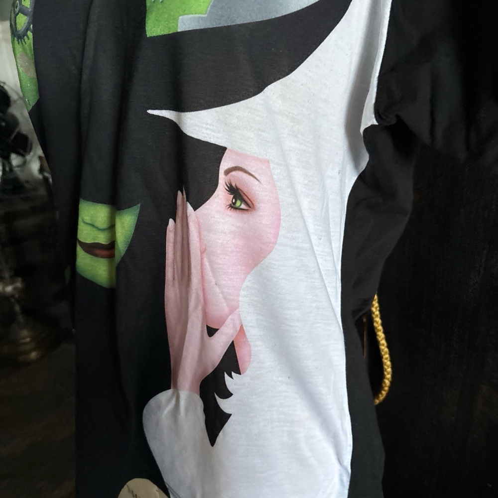 WICKED Elphaba Wear by Merch-Kin’s of OZ -Youth 4X =L Witch Faces on Black Shirt